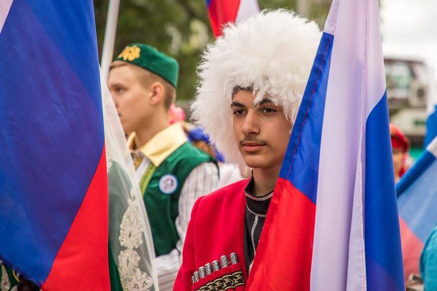 Here is the snow‑white papakha on a young man’s head again