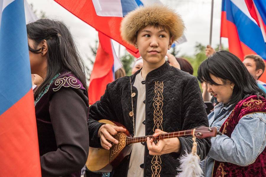 The young men make sure their musical instruments are in tune