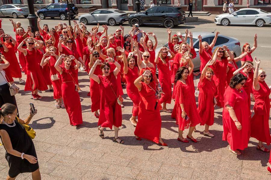 The women and girls enthusiastically greet passersby