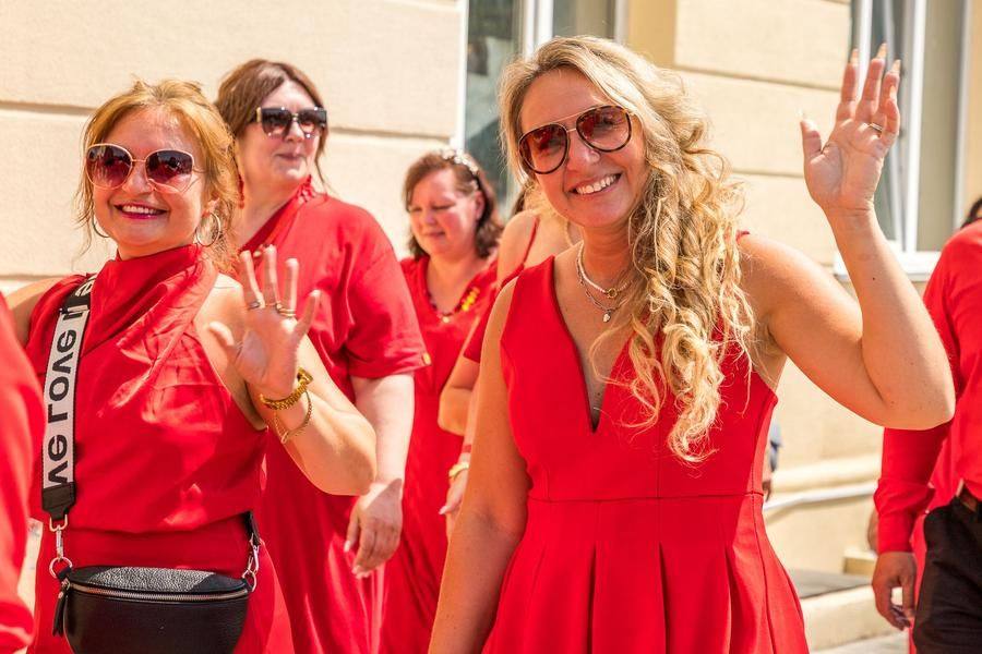 Each lady in red is expected to exceed her daily quota of greetings within an hour :)