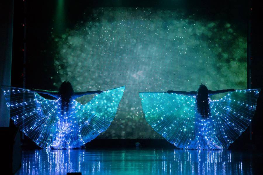 The opening number, built around a multicultural image, begins in complete darkness