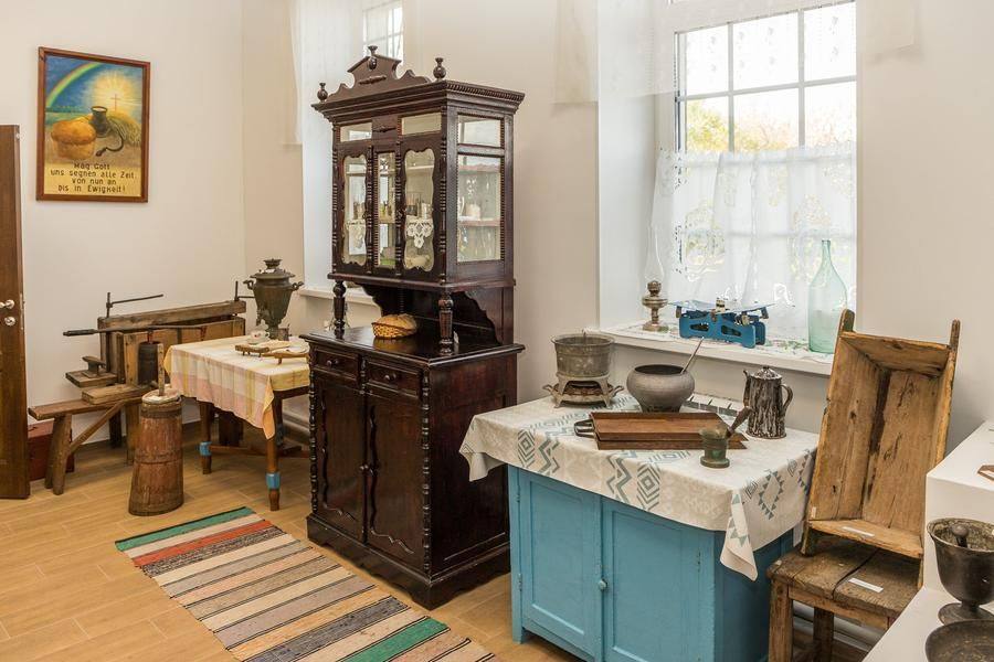 A graceful century‑old sideboard made by an artisan sits alongside homemade furniture that may have been crafted by the