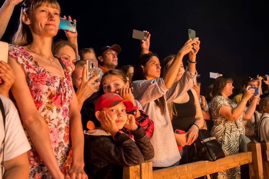 Captivated spectators rush to capture the show to share with friends