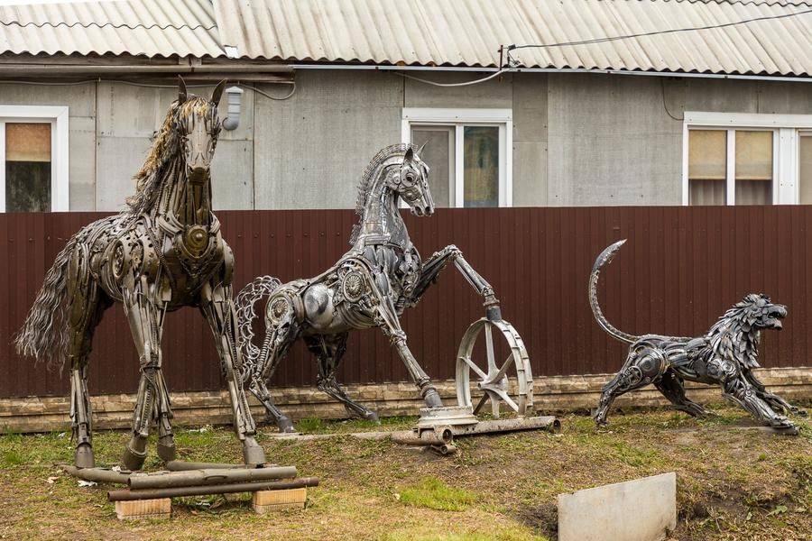One street is decorated with sculptures made from car and agricultural machinery parts