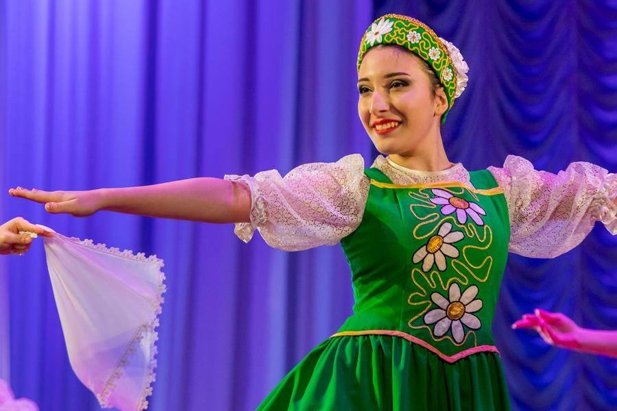 The bright outfits complement the cheerful, rhythmic music