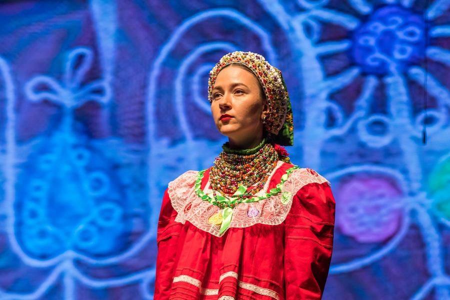 Details of the cut and embroidery are projected onto a large screen