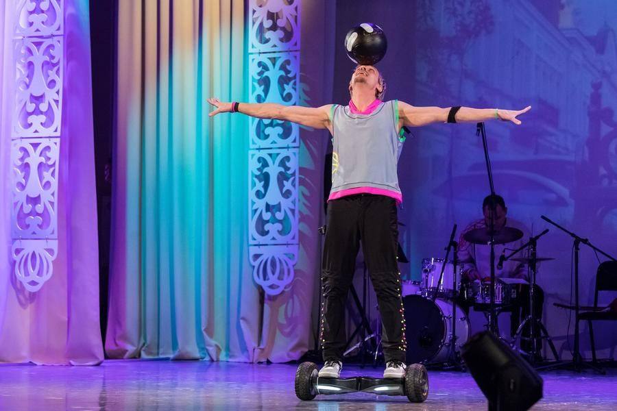 Suddenly, a circus artist appears on a gyroscooter