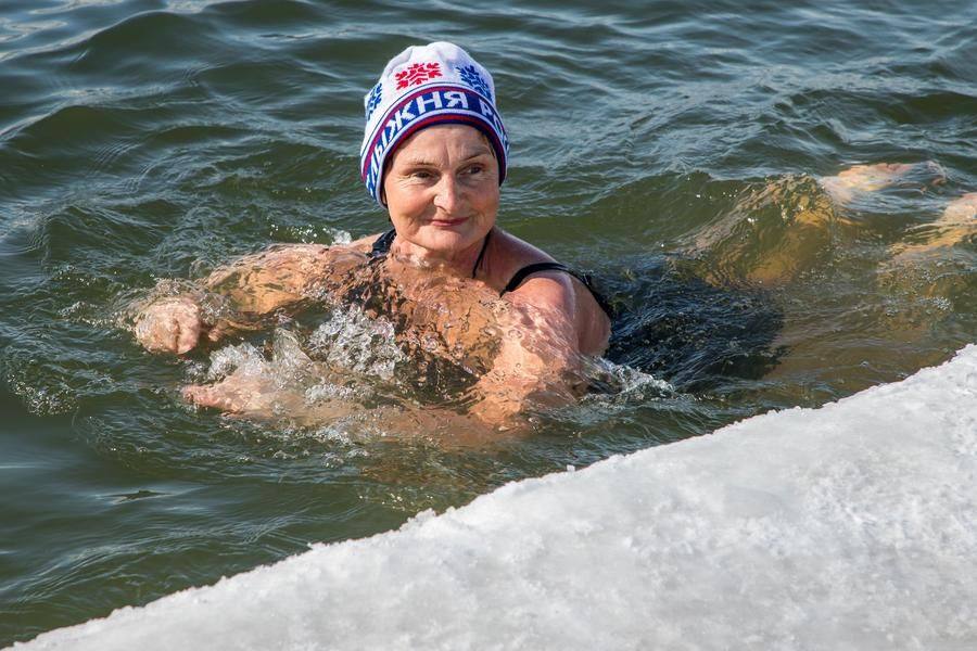 As the ice swimmers joke, since the water is warmer than the air in winter, you can actually get warm in it!