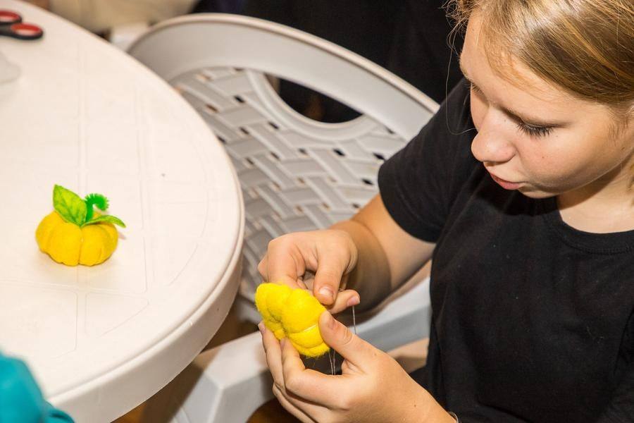 Both adults and children gather to make themed souvenirs
