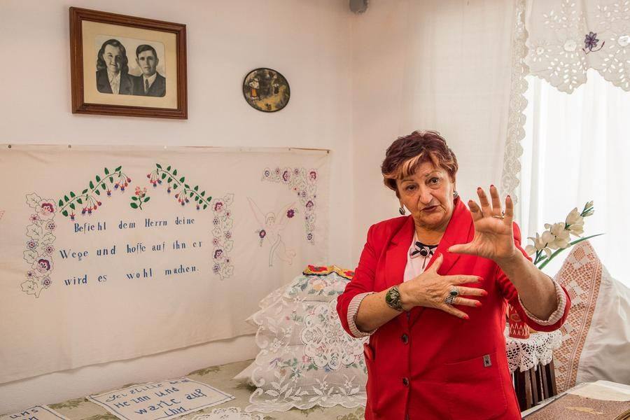 By tradition, next to the married couple’s bed there’s a family photo and a spruch — a saying embroidered by the young
