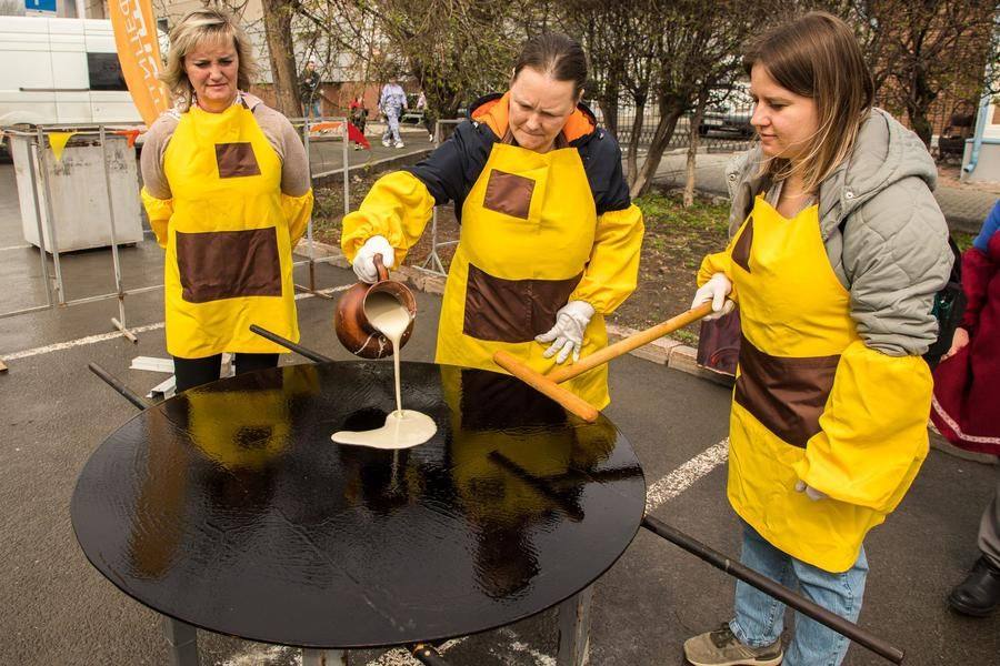 Pancake chefs are being recruited right from the crowd — volunteers are welcome