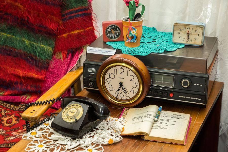 A typical side table of the era: to call the airport information desk, look up the number in a phone book beforehand