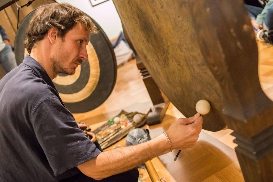 Sound therapy master Dmitry Kundyus creates vibrations and controls the rhythm