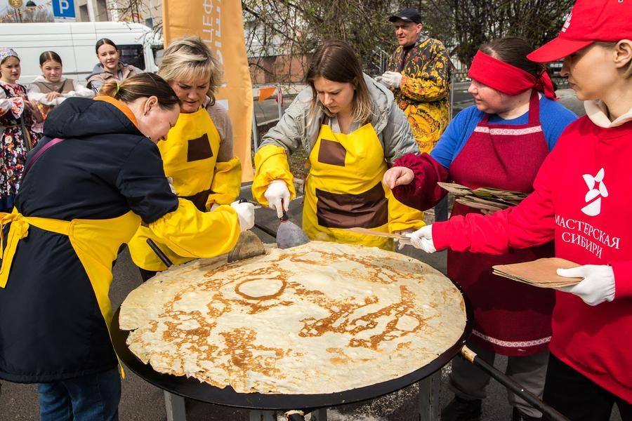 The pancake chefs slice it, and volunteers serve the portions