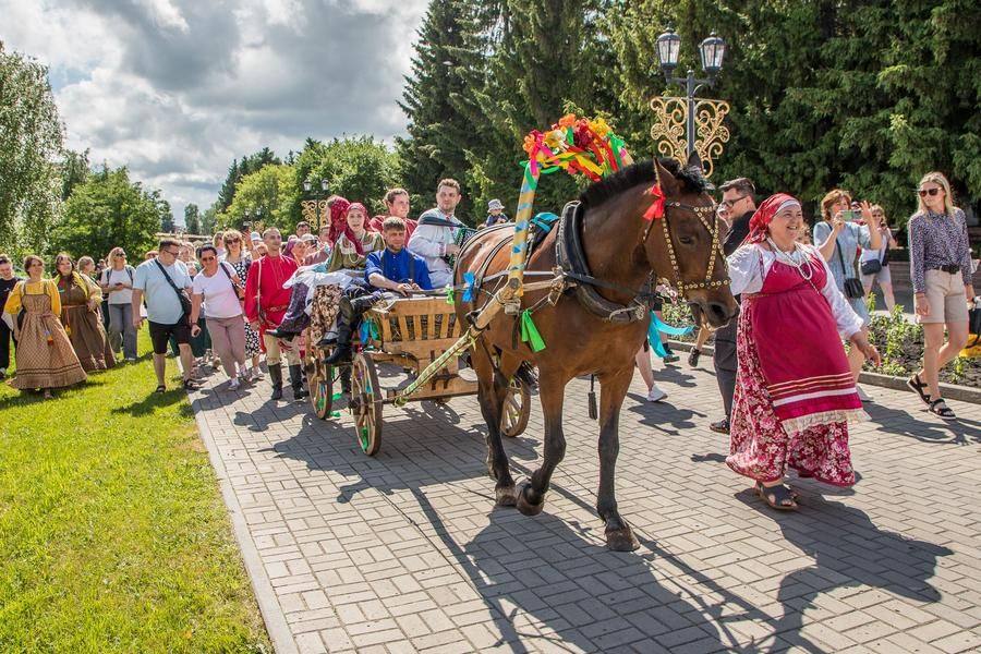 The wedding procession travels along the village’s main street