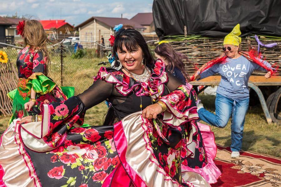 The beautiful women invite everyone who walks by to join the dance