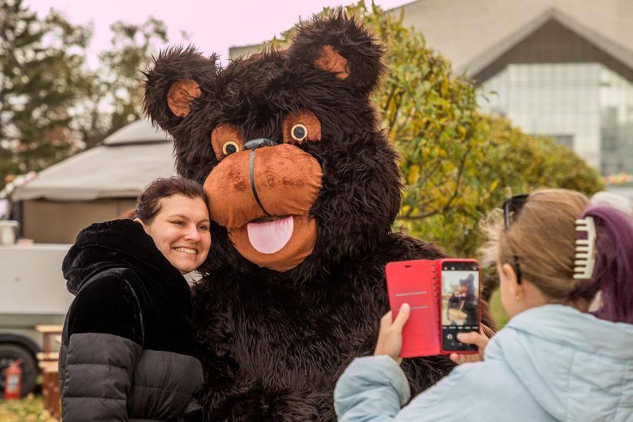 The friendly bear seems eager to give everyone a warm hug!