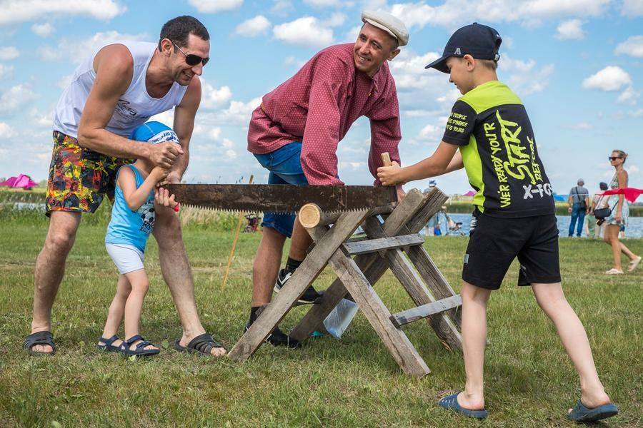 Kids can’t tackle the “Firewood Preparation” station without adult help