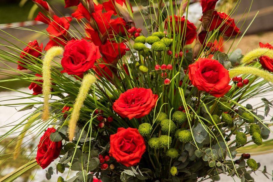 Stylized vases for the surrounding bouquets are made from pipe fragments