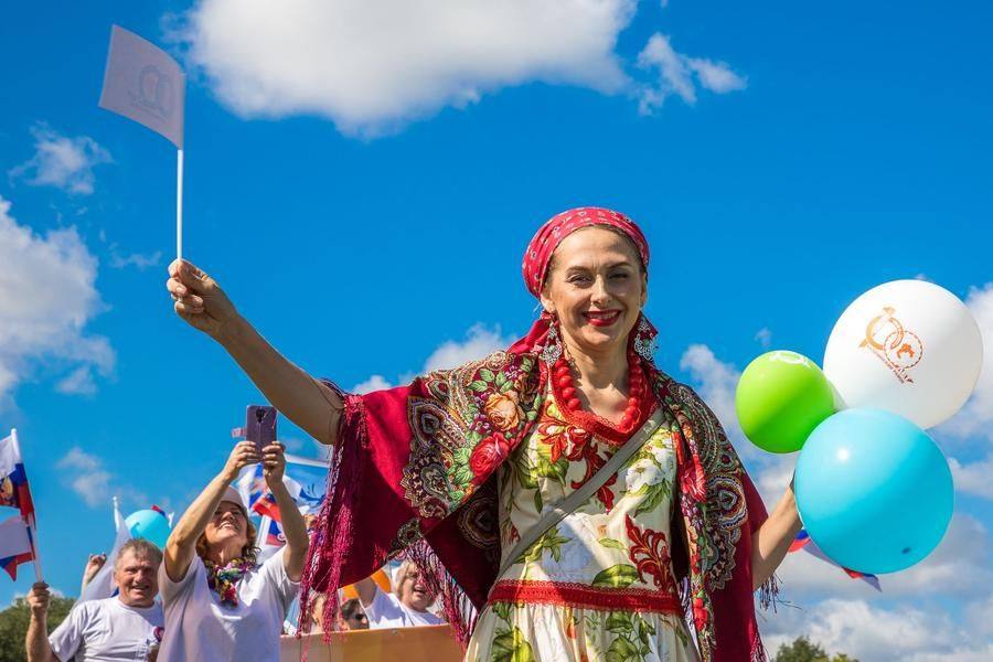 Hundreds of people marched through the town’s streets, carrying balloons and flags