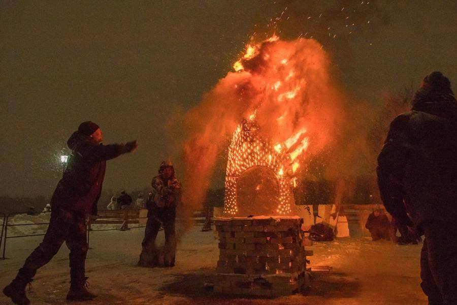 The sawdust is being thrown into the fire synchronously from four sides at once