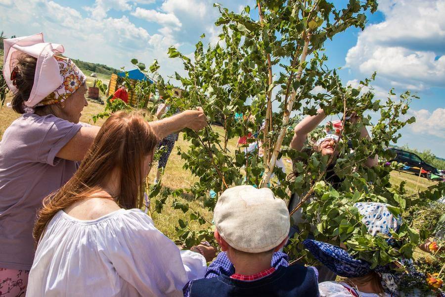 As they tie ribbons to a birch tree, the participants make wishes