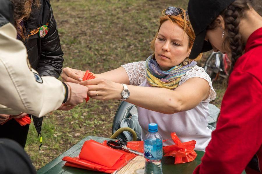 Teachers help craft flowers that will become part of an art installation