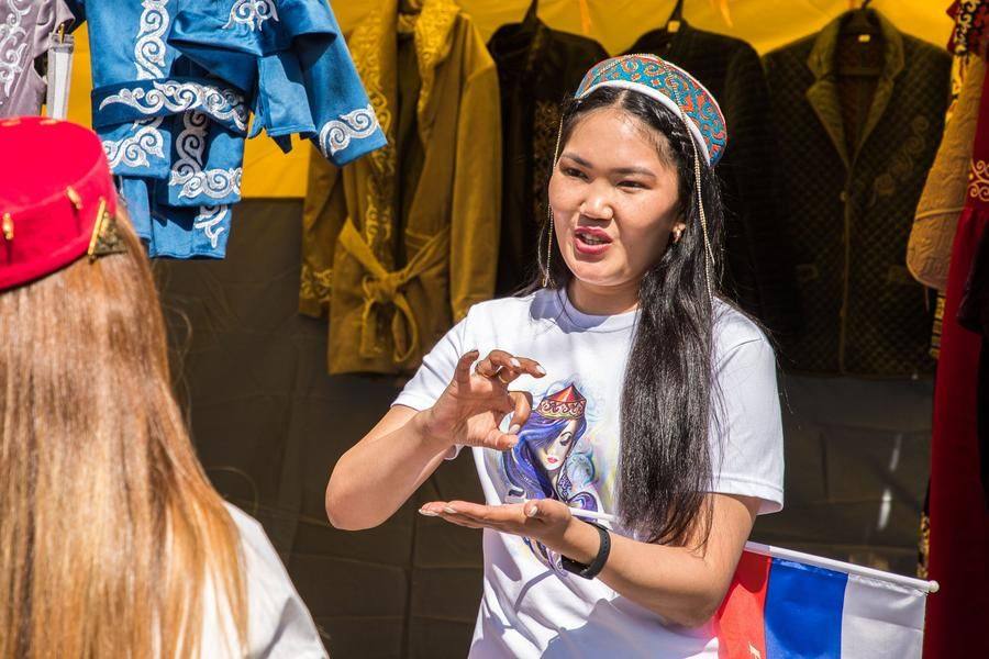The market stalls are bustling with activity, and the style of the items on display is noticeably different now