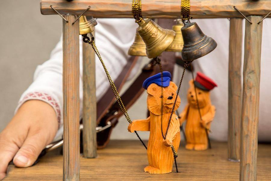 It’s a miniature belfry decorated with friendly‑looking bears