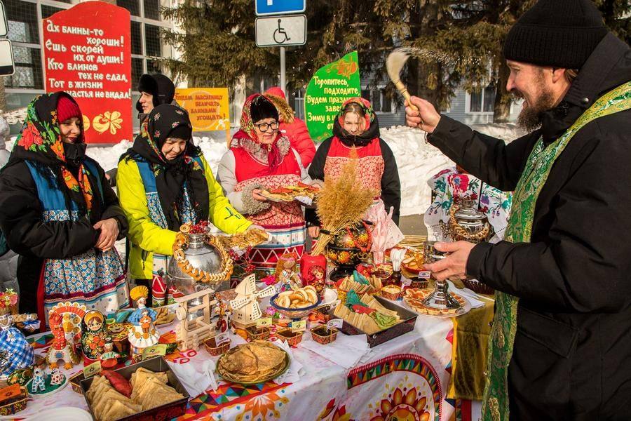 An Orthodox priest blesses the generous feast