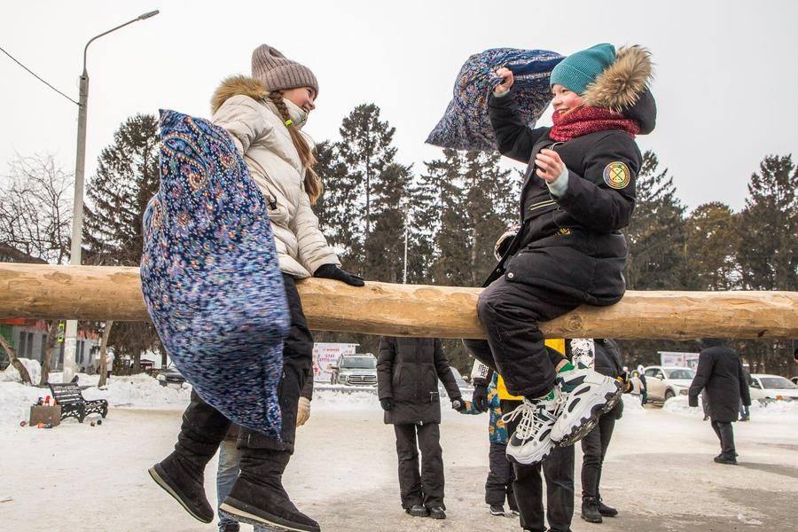 Girls are just as eager to climb onto the log for their turn in the duels