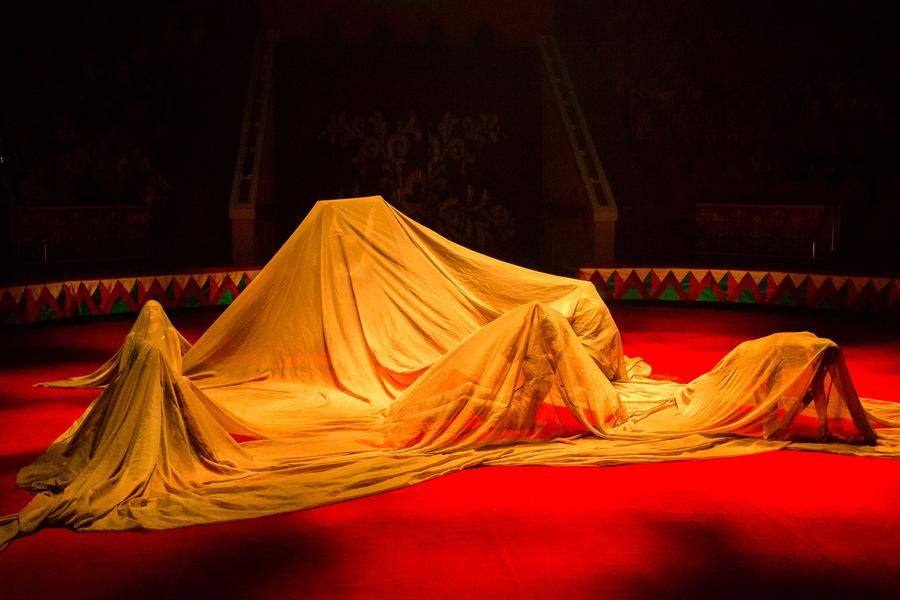 The lighting changes, and the circus action transports the audience to distant dunes