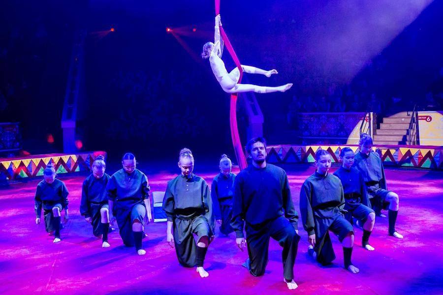 The theatrical action unfolds both on the arena and under the dome