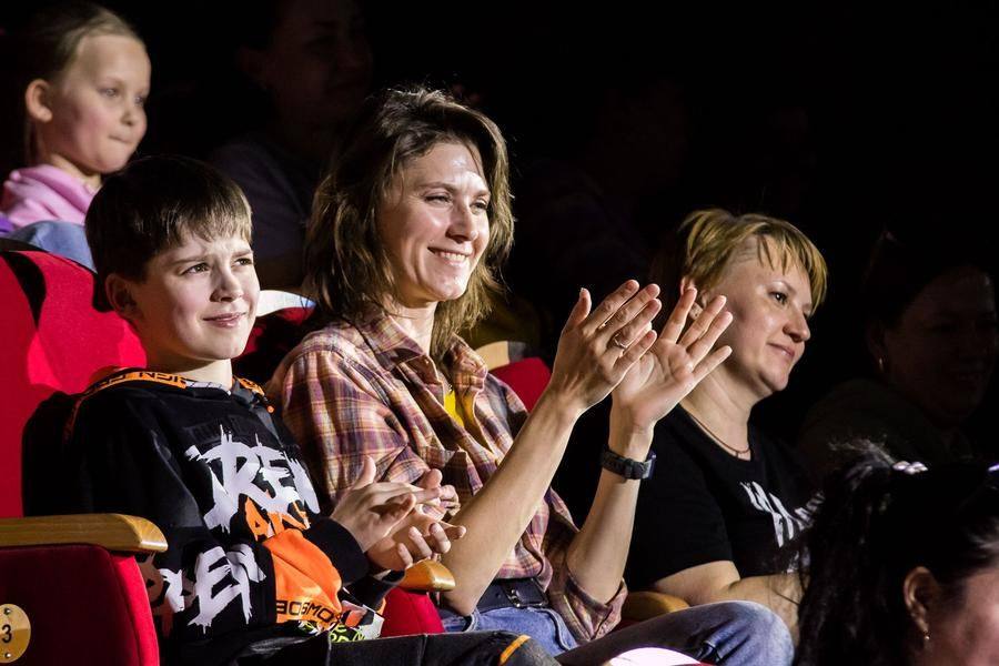 The audience applauds not just them, but all the young circus performers